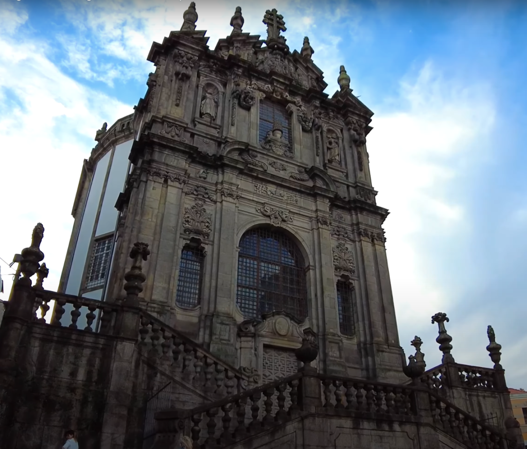 The towering baroque bell tower of Igreja dos Clérigos, a prominent landmark against Porto's skyline.