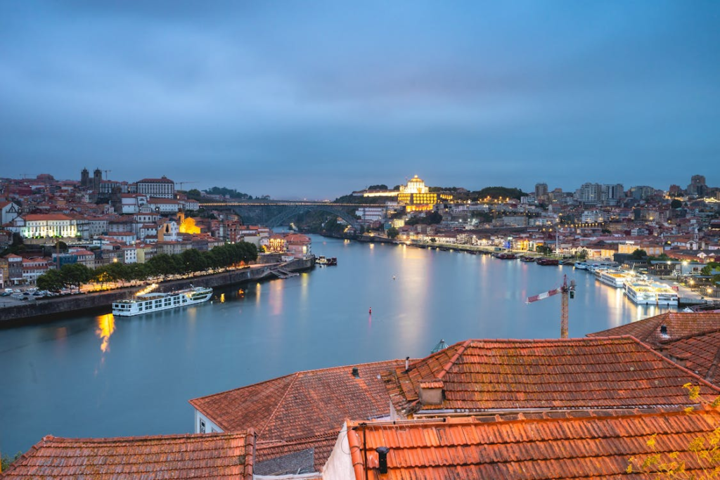 Panoramic view of Porto along the Douro River, showcasing the historic Ribeira district with its colorful buildings and lively waterfront.